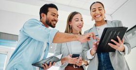 Business people, teamwork and collaboration on tablet for data analytics, marketing results and comparison in office. Professional group of women and man for digital, social media or startup project.