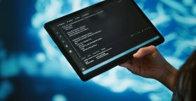 Close up of IT professional using tablet, building AI algorithms Software developer with tablet programming artificial intelligence computing simulating human brain. Close up of IT professional using device, building AI machine learning algorithms, camera A