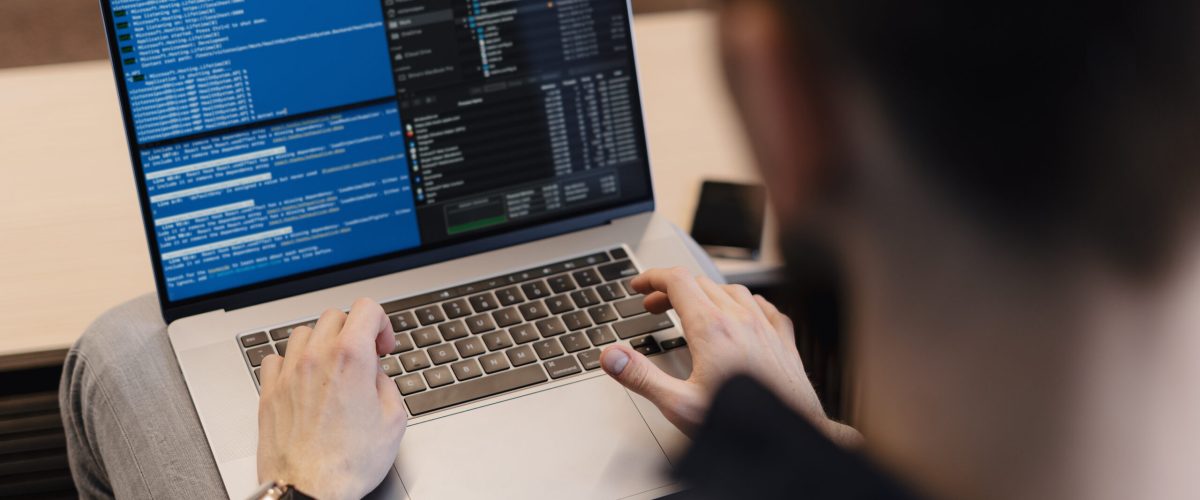 Man working on computer. Young it worker using laptop in the office, Internet marketing, technology, finance, business concept