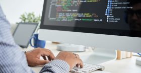 Coding man Cropped image of It specialist working on code