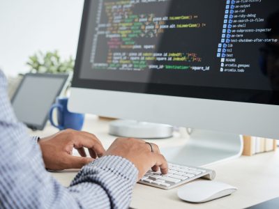 Cropped image of It specialist working on code
