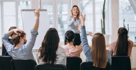 female-speaker-giving-presentation-hall-university-workshop-audience-conference-hall