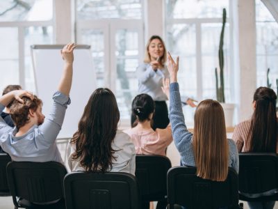 female-speaker-giving-presentation-hall-university-workshop-audience-conference-hall