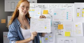 female-web-designer-with-papers-notes-office female-web-designer-with-papers-notes-office