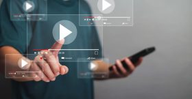 Online movie streaming with smartphone. People watching movie on Online movie streaming with smartphone. People watching movie on mobile phone with an imaginary video player service. Playing online video, online streaming. Searching videos on online platforms.