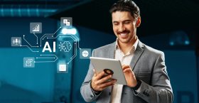 Man in a suit smiles while interacting with a tablet, utilizing artificial intelligence applications. The contemporary office environment enhances the technological vibe.