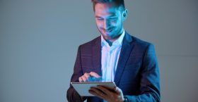smiling-young-businessman-using-tablet-modern-suit-blue-background-modern-business-technology a-medium-shot-of-a-tech-savvy-entrepreneur-in-semi-RAd72jCHTwSYGeRCfsWMig-Pcvk3Ie9QEaxKbIJFhESEQ-topaz-standard v2-4x.jpeg