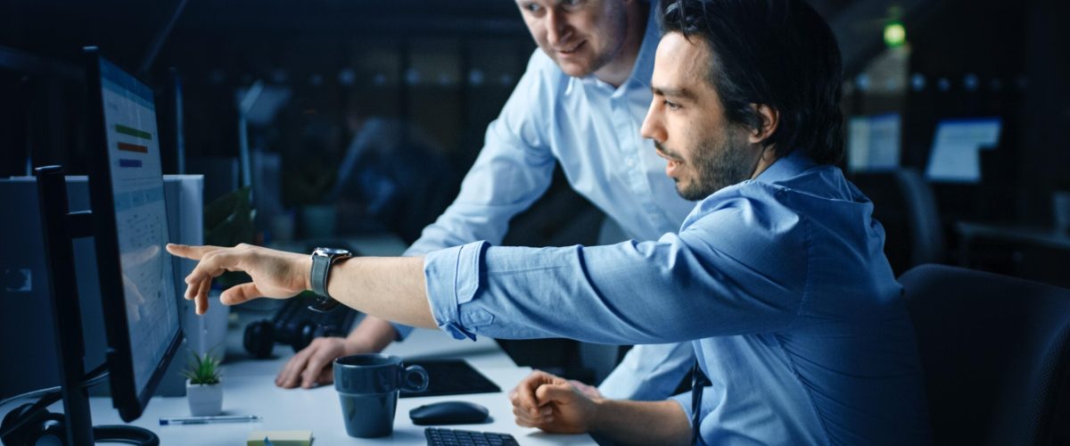 two-men-working-computer-with-watch-screen